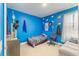 Blue bedroom featuring neutral wood-look flooring and a cloudscape wall design at 2668 Coachman Dr, Deltona, FL 32738