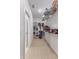 Spacious walk-in closet with built-in shelving and wood-look flooring at 2668 Coachman Dr, Deltona, FL 32738