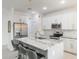 Well-lit kitchen with a large island featuring a sink, stainless steel appliances, and stylish pendant lighting at 2668 Coachman Dr, Deltona, FL 32738