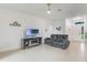 Bright living room with tiled floors, modern furniture, and large windows letting in ample sunlight at 2668 Coachman Dr, Deltona, FL 32738
