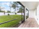 Screened-in patio overlooking a well-maintained backyard with lush green grass and mature trees at 2668 Coachman Dr, Deltona, FL 32738