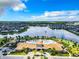 Stunning aerial view showcasing a resort-style pool and clubhouse by a serene lake in a residential community at 2698 Chantilly Ave, Kissimmee, FL 34741