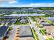 Panoramic aerial view showcasing a residential neighborhood with a serene lake and beautiful landscaping at 2698 Chantilly Ave, Kissimmee, FL 34741