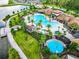 Aerial view of a resort-style pool, splash pad, and lounging areas in a Gathering-friendly community at 2698 Chantilly Ave, Kissimmee, FL 34741