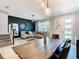 Stylish dining area showcasing a rustic table, elegant lighting, and a view into the inviting living space at 2698 Chantilly Ave, Kissimmee, FL 34741