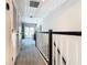 Bright upstairs hallway with carpet flooring and access to a balcony at 2698 Chantilly Ave, Kissimmee, FL 34741