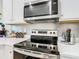 Close-up of a kitchen with sleek stainless steel appliances and stylish backsplash, creating a modern aesthetic at 2698 Chantilly Ave, Kissimmee, FL 34741