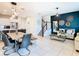 Open-concept living and dining area with stylish decor, tile floors, and a staircase at 2698 Chantilly Ave, Kissimmee, FL 34741