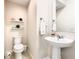 Cozy powder room featuring a pedestal sink, updated fixtures, and tasteful decor at 2698 Chantilly Ave, Kissimmee, FL 34741