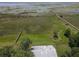 Aerial view shows the roof, lake access, and surrounding greenery at 2700 Cherokee Rd, St Cloud, FL 34772