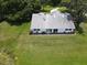 Aerial view of home with a large yard, mature trees, and a private driveway at 2700 Cherokee Rd, St Cloud, FL 34772