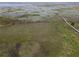 Expansive aerial view showcases the property's scenic surroundings and its proximity to the lake at 2700 Cherokee Rd, St Cloud, FL 34772