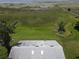 Aerial view showcasing the home's roof, surrounding greenery, and a scenic lake view in the distance at 2700 Cherokee Rd, St Cloud, FL 34772