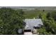 Bird's eye view of home with mature trees, waterfront access and expansive lawn at 2700 Cherokee Rd, St Cloud, FL 34772