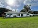 Well-maintained single-story home featuring a lush green lawn and neatly trimmed landscaping at 2700 Cherokee Rd, St Cloud, FL 34772