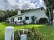 Charming home exterior featuring lush landscaping, a well-manicured lawn, and bright natural light at 2700 Cherokee Rd, St Cloud, FL 34772