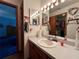 Comfortable bathroom featuring a single sink vanity, lighting, and decorative towel rack at 2700 Cherokee Rd, St Cloud, FL 34772