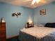 Cozy bedroom featuring a ceiling fan, dresser, and a comfortable bed at 2700 Cherokee Rd, St Cloud, FL 34772