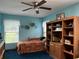 Charming bedroom with a ceiling fan, window, and built in shelving unit at 2700 Cherokee Rd, St Cloud, FL 34772