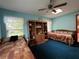 Bright bedroom featuring two beds, a window with natural light and a ceiling fan at 2700 Cherokee Rd, St Cloud, FL 34772