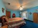 Comfortable bedroom with unique fireplace, french doors, and classic ceiling fan at 2700 Cherokee Rd, St Cloud, FL 34772