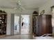 Bright bedroom featuring tile flooring, ceiling fan, and glass doors to the outside at 2700 Cherokee Rd, St Cloud, FL 34772