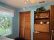 Bedroom features a ceiling fan, a window, and a closet with shutter doors at 2700 Cherokee Rd, St Cloud, FL 34772