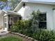 Home exterior highlighting beautiful landscaping, screened porch, and inviting curb appeal at 2700 Cherokee Rd, St Cloud, FL 34772