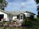 Charming home exterior showcasing manicured landscaping, screen porch, and a serene setting at 2700 Cherokee Rd, St Cloud, FL 34772