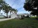 This beautiful home features mature trees, a well-manicured lawn, an attached two-car garage, and eye-catching flower beds at 2700 Cherokee Rd, St Cloud, FL 34772