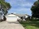 Charming single-Gathering home with an attached two-car garage, manicured landscaping, and a well-kept lawn at 2700 Cherokee Rd, St Cloud, FL 34772