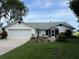 Charming single-story home featuring an attached two car garage, lush front yard and a well maintained landscape at 2700 Cherokee Rd, St Cloud, FL 34772