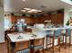Bright, open kitchen boasts a breakfast bar, eat in kitchen, and wood cabinetry at 2700 Cherokee Rd, St Cloud, FL 34772