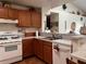 Efficient kitchen layout featuring light colored countertops, white appliances, and wooden cabinetry at 2700 Cherokee Rd, St Cloud, FL 34772