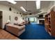 Spacious living room featuring blue carpet, vaulted ceilings with skylights, and cozy fireplace at 2700 Cherokee Rd, St Cloud, FL 34772