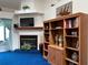 Cozy living room featuring a fireplace and built-in shelving at 2700 Cherokee Rd, St Cloud, FL 34772