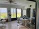Bright sunroom with tile floors and views of the outdoor landscape and table set for dining at 2700 Cherokee Rd, St Cloud, FL 34772