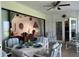 Bright sunroom leading into the living room, with table set for dining at 2700 Cherokee Rd, St Cloud, FL 34772