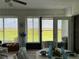 Bright sunroom with tile floors and views of the outdoor landscape and table set for dining at 2700 Cherokee Rd, St Cloud, FL 34772