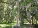Scenic landscape with mature trees draped in Spanish moss create a tranquil setting at 2700 Cherokee Rd, St Cloud, FL 34772