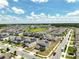 Expansive aerial view of a community featuring modern homes and lush landscaping at 2759 Slash Way, St Cloud, FL 34771