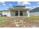 Home featuring a backyard with a covered patio and grassy yard at 2759 Slash Way, St Cloud, FL 34771