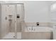 Elegant bathroom showcasing a glass-enclosed shower and a luxurious soaking tub at 2759 Slash Way, St Cloud, FL 34771