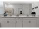 Well-lit bathroom featuring double sinks, modern fixtures, and a large vanity mirror at 2759 Slash Way, St Cloud, FL 34771