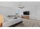 A spacious and bright primary bedroom with a large bed and a comfortable seating area at 2759 Slash Way, St Cloud, FL 34771