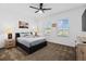 Inviting bedroom with a ceiling fan, comfortable queen bed, and carpeted floor at 2759 Slash Way, St Cloud, FL 34771