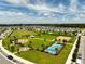 View of the community park featuring a playground, a covered picnic area, sports courts, and manicured green spaces at 2759 Slash Way, St Cloud, FL 34771