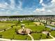 View of the community park featuring a playground, a covered picnic area, sports courts, and manicured green spaces at 2759 Slash Way, St Cloud, FL 34771