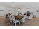 Bright dining room with a wooden table, seating for eight, and views into the kitchen area, perfect for entertaining guests at 2759 Slash Way, St Cloud, FL 34771
