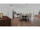 Open-concept dining area featuring a large wooden table, seating for eight, and seamless transition to the kitchen and living room at 2759 Slash Way, St Cloud, FL 34771